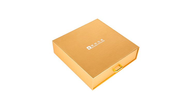 RX Packaging's golden drawer-style packaging box for chocolate